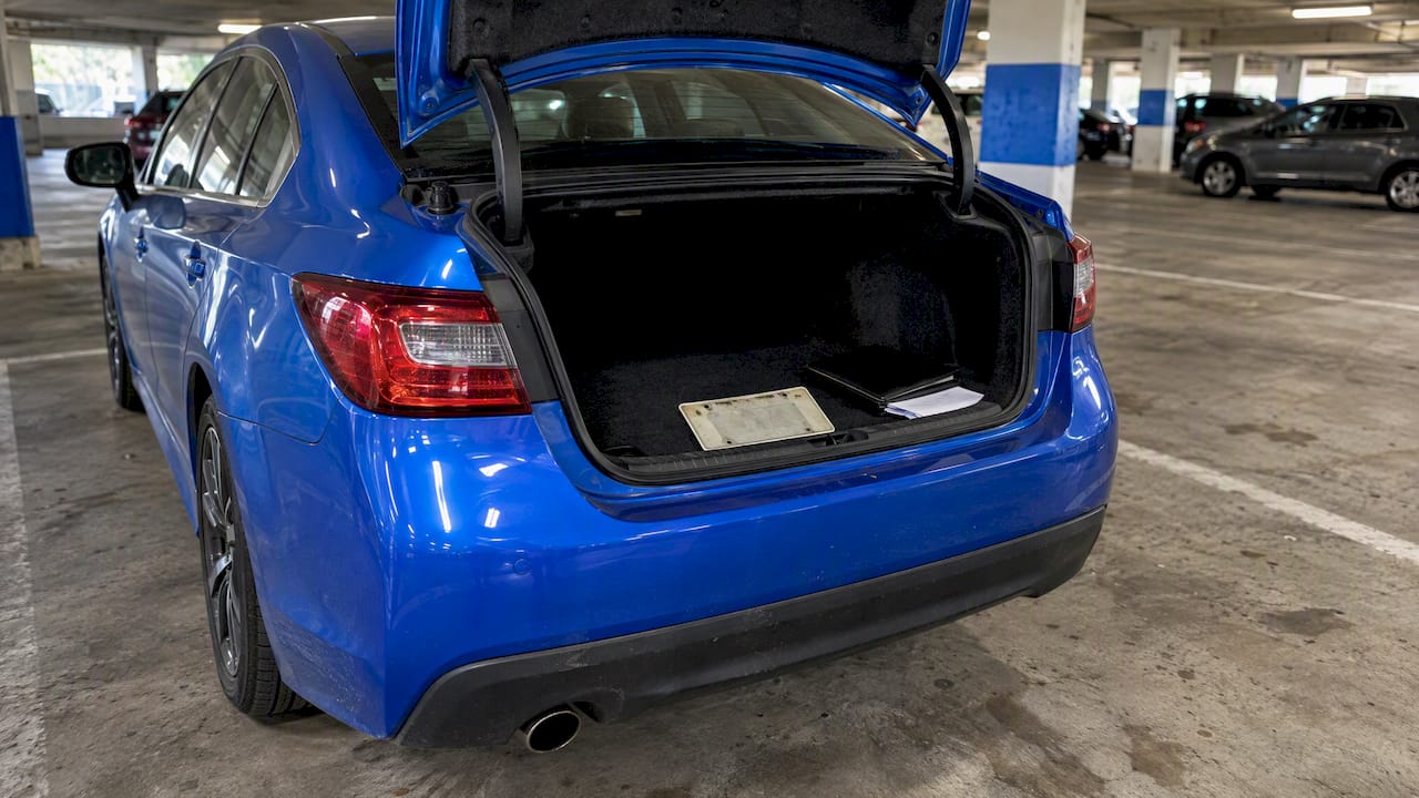 Car sale papers and removed plate in trunk