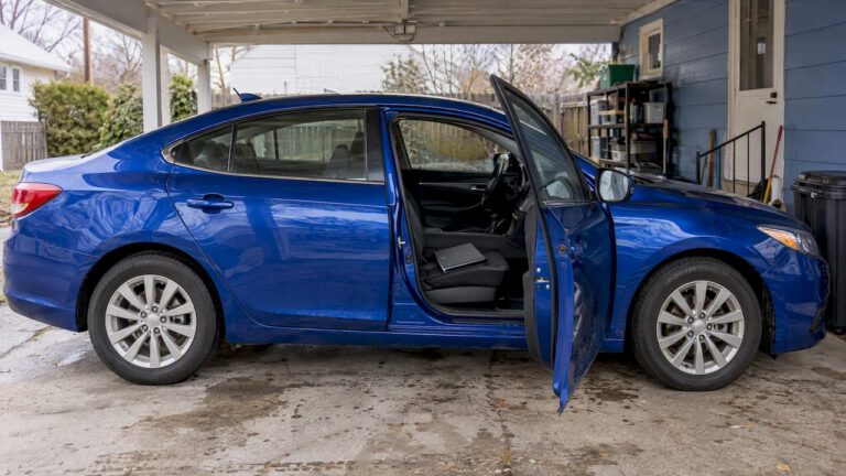 Blue sedan beside lien sale paperwork
