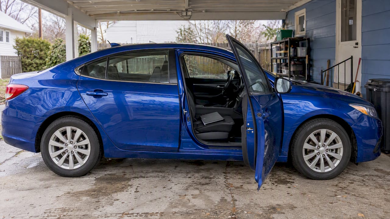 Blue sedan beside lien sale paperwork