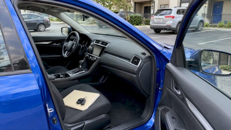 Blue sedan with a closed folder and keys