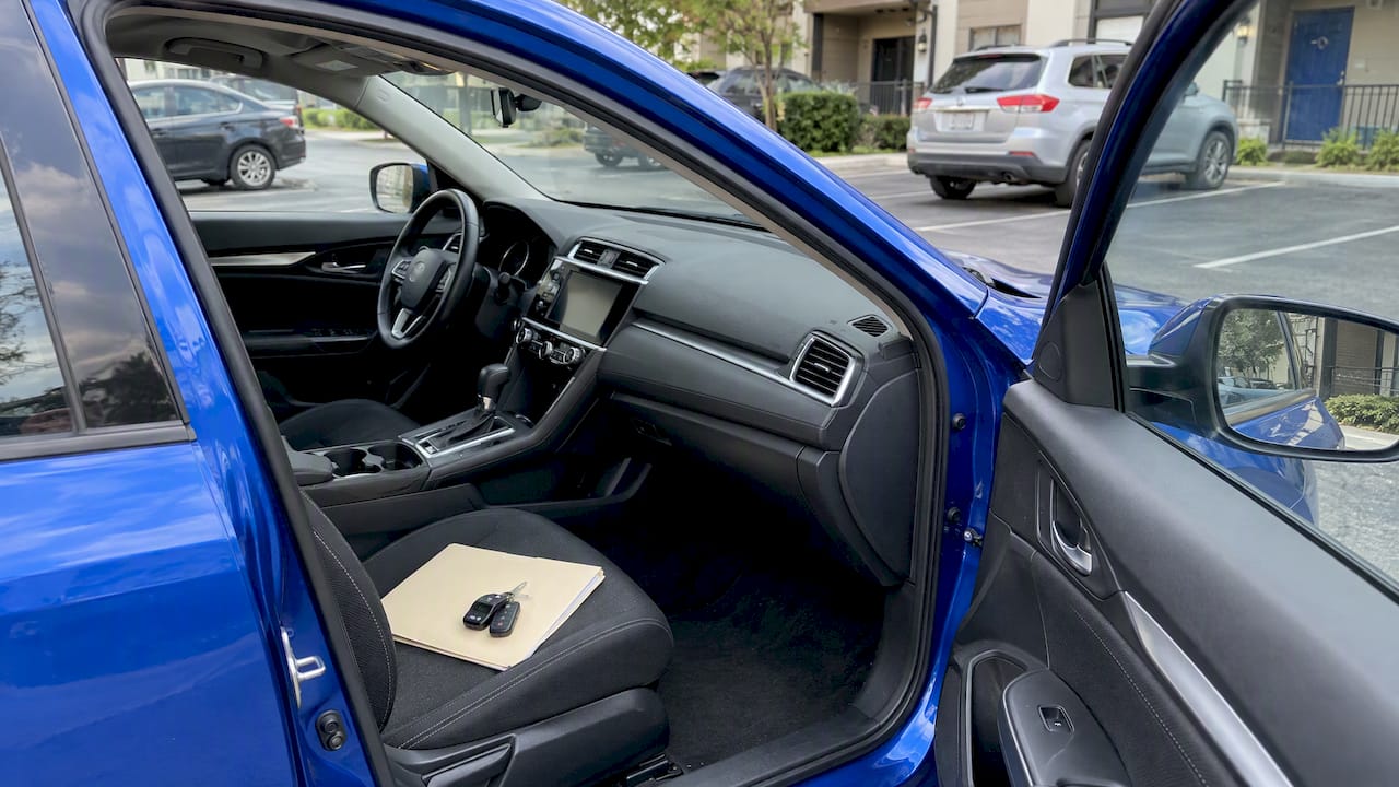 Blue sedan with a closed folder and keys